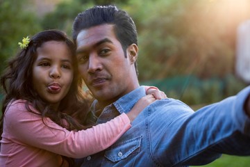 Fototapeta premium Father and daughter taking a selfie