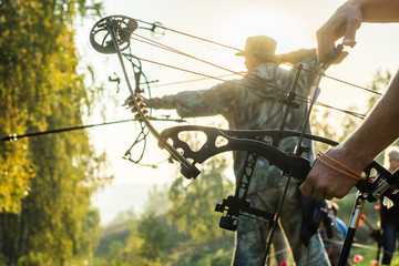 Archers silhouettes on forest background
