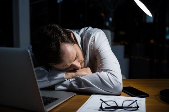 Tired Businessman Sleeping On The Desk