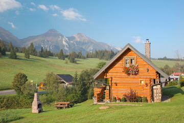 Naklejka premium Panorama of Belianske Tatry mountains and the little blockhouse in Zdiar village.