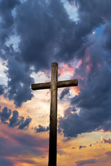 Christian cross over sunset background