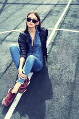 young stylish hipster woman outdoor, wearing sunglasses
