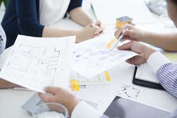 People to a meeting while looking at the blueprint in the company