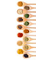 Various spices in wooden spoons.