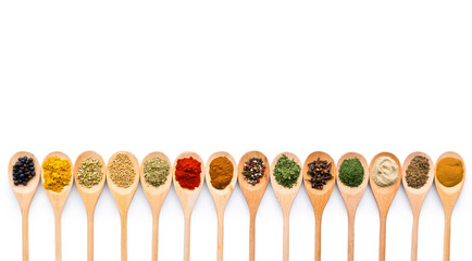 Various spices in wooden spoons.