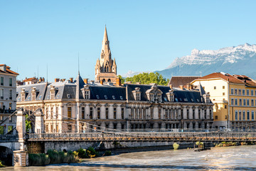 Obraz premium Morning cityscape view with mountains, river and bridge in Grenoble city on the south-east of France