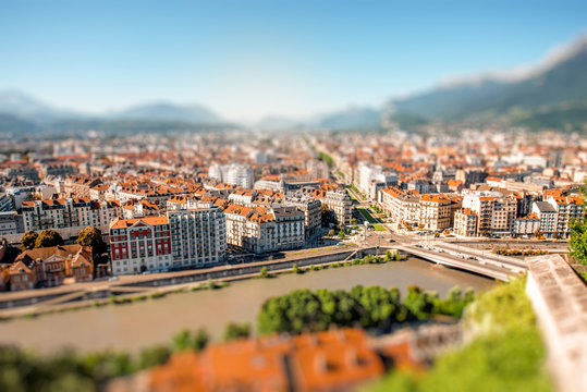 Morning cityscape view on the old town with mountains and river in Grenoble city on the south-east of France. Blurred image with tilt-shift technic