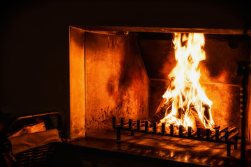 Fire in the old fireplace in dark room