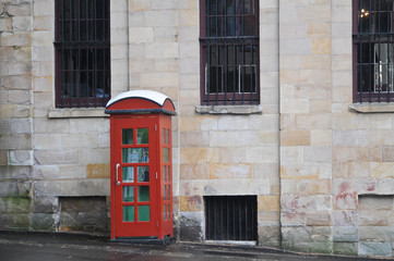 Red public phone booth in and old London town of the United Kingdom England