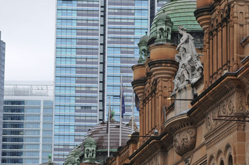 Fototapeta na wymiar Old QVB Building in Sydney among high rise apartments