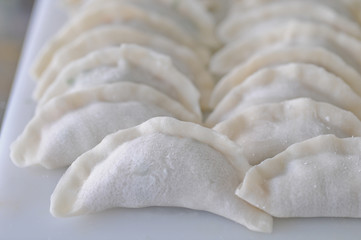 Chinese raw white pork dumpling stack on a kitchen