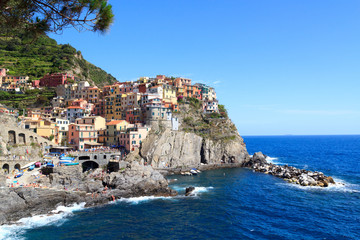 Fototapeta na wymiar Cinque Terre village Manarola with colorful houses and Mediterranean Sea, Italy
