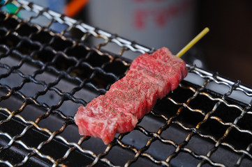 Marbled martinated fresh Hida Japanese beef skewer grilled on ch