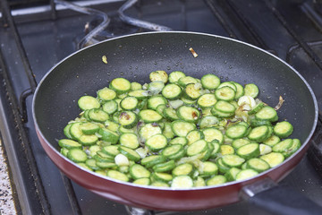 sliced courgette in a fryning pan