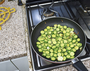 sliced courgette in a fryning pan