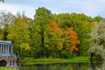 Autumn landscape in the Park with a marble bridge