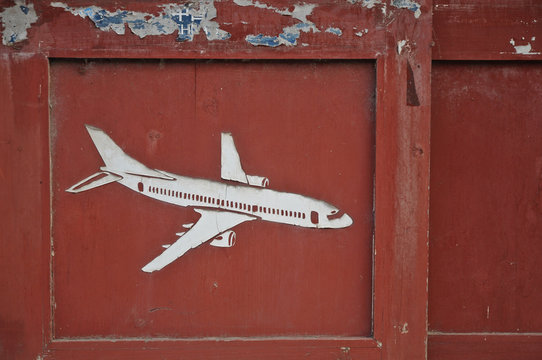 Aeroplane carved on old wooden door pane