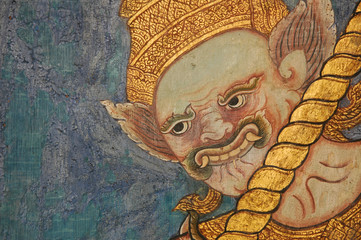 Thai ancient fresco painting of golden face of giant on wooden wall. 