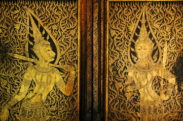 Golden antique drawing of Thai guarden angels on temple door