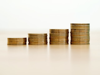 Stack of golden coins growing up stack. Growth business and financial concept.