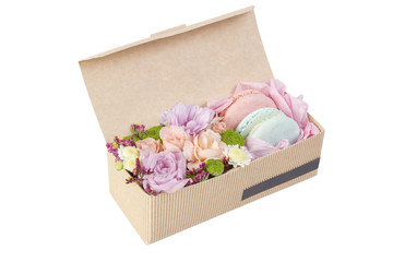 Colorful macaroons in a paper box on white background