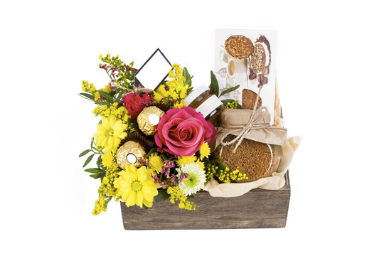 arrangement of flowers and coffee in a box, white background