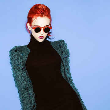 Glamorous lady with red hair and style sunglasses trend.
