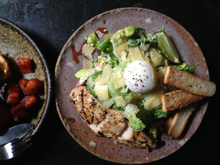 Breakfast Cesar vegetable green salad with grilled chicken and half boiled egg