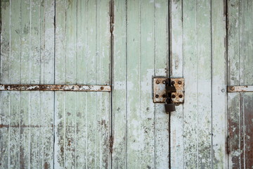 Blue old town wooden door locked with old padlock