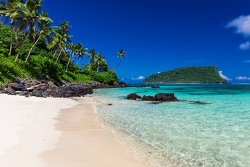 Tropical Lalomanu beach on Samoa Island with coconut palm trees