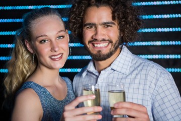 Couple holding glass of champagne in bar