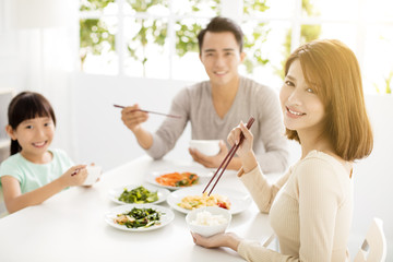 Obraz na płótnie Canvas happy asian young Family enjoy their dinner