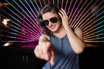 Pretty female DJ playing music