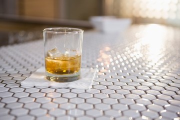 Glass of whisky on bar counter