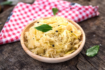 Steamed sauerkraut on old wooden background