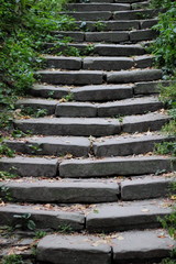 Steps of old stone stairs in the park in early autumn