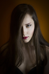 Fototapeta premium Portrait of a beautiful young girl on a dark background