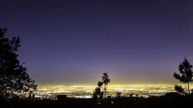 Time lapse with pan right motion of Los Angeles aerial cityscape overlook at night