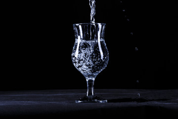 Portrait of the fault of the glasses of water on a black background