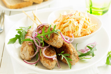 Kyufta kebab with salad close-up.