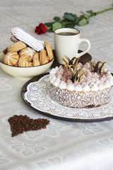 Portrait of a slice of cake with tea and a rose on a table