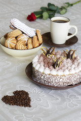 Portrait of a slice of cake with tea and a rose on a table
