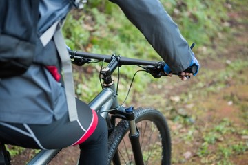 Mid section of male mountain biker riding