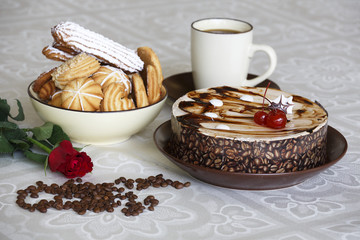 Portrait of a slice of cake with tea and a rose on a table