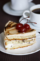 Portrait of a slice of cake with tea and a rose on a table
