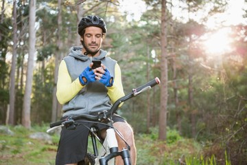 Mountain biker using mobile phone