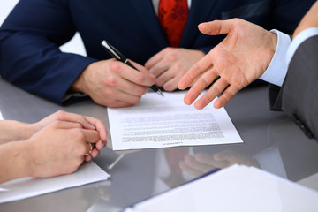 Business people discussing contract. Close up of male hand pointing to the paper