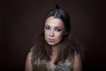 Portrait of a beautiful girl in the style of Indian America in a fur vest