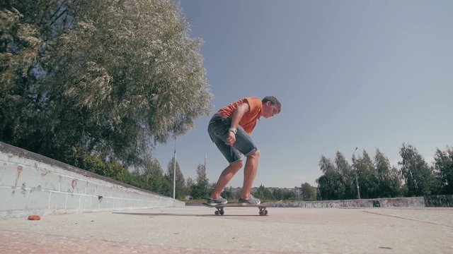 Skateboarder doing tricks in a city. Slow motion, 100 fps. HD