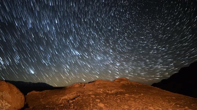 Astrophotography Time Lapse With Zoom Out Motion Of Star Trails Over Native American Petroglyphs In Eastern Sierra, California